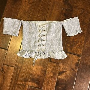 Peixoto cropped top w/ ruffle detailed hem and off shoulder sleeves.